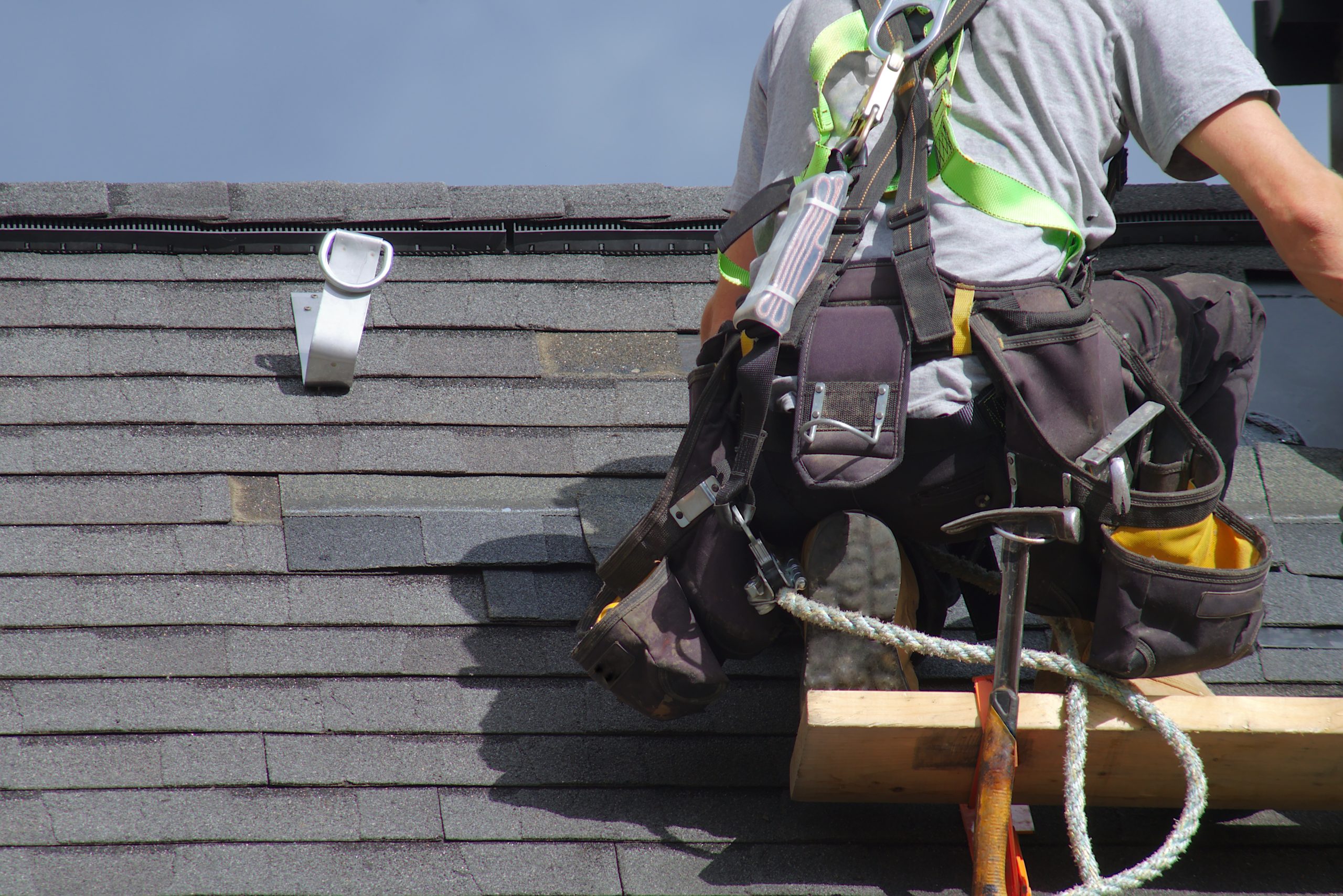 roof repair construction worker roofer man roofing security rope