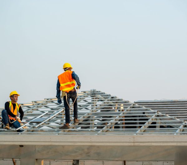 Roofer working on roof,Professional roofer are installing new roof on top roof of modern house.